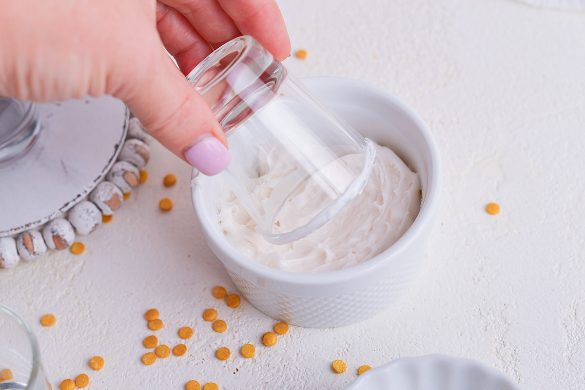 shot glass dipping into frosting