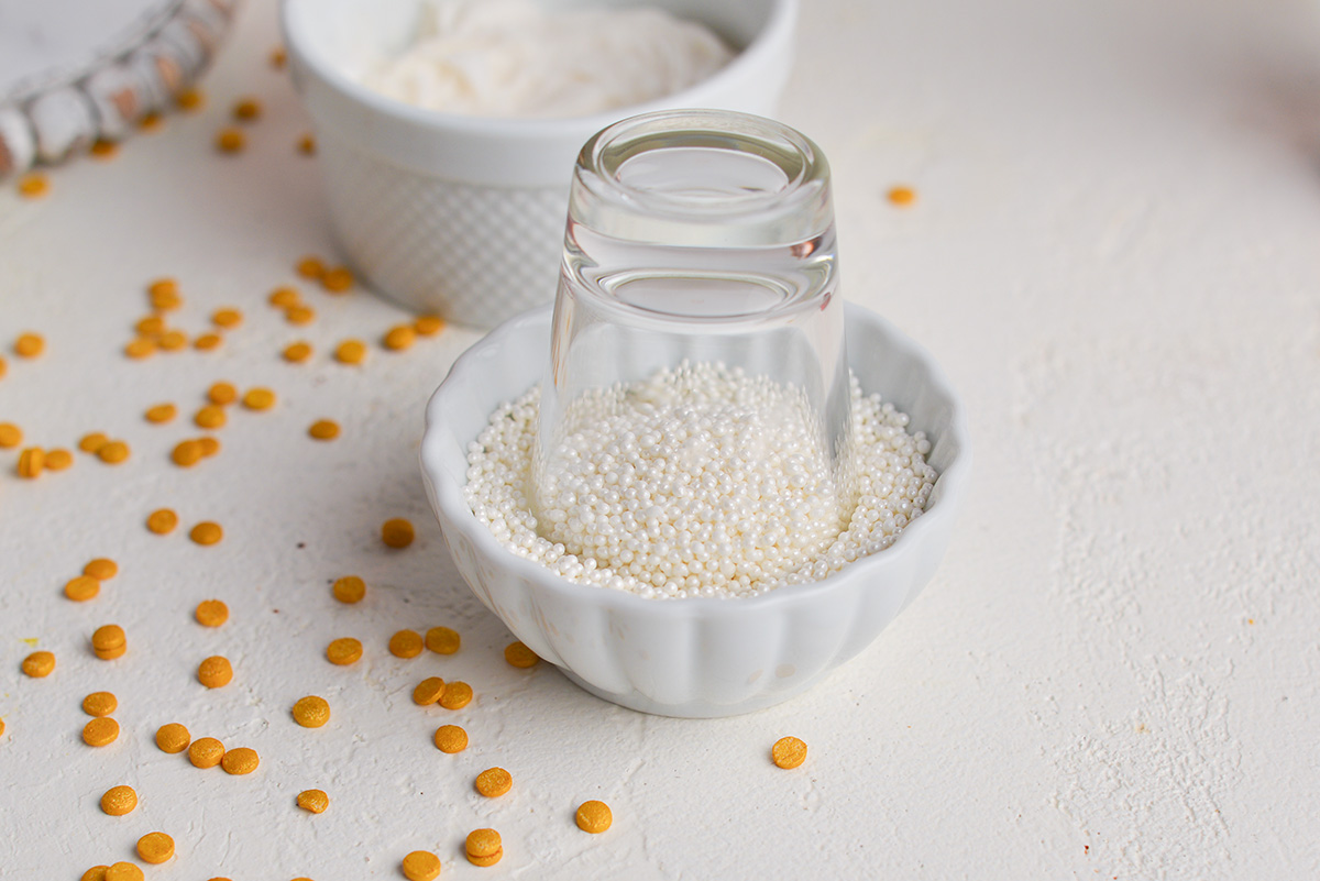 shot glass dipping into sprinkles