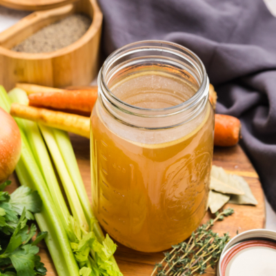 angled shot of mason jar of turkey stock