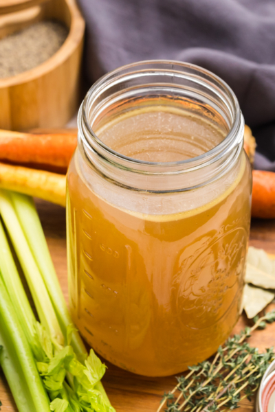 angled shot of mason jar of turkey stock