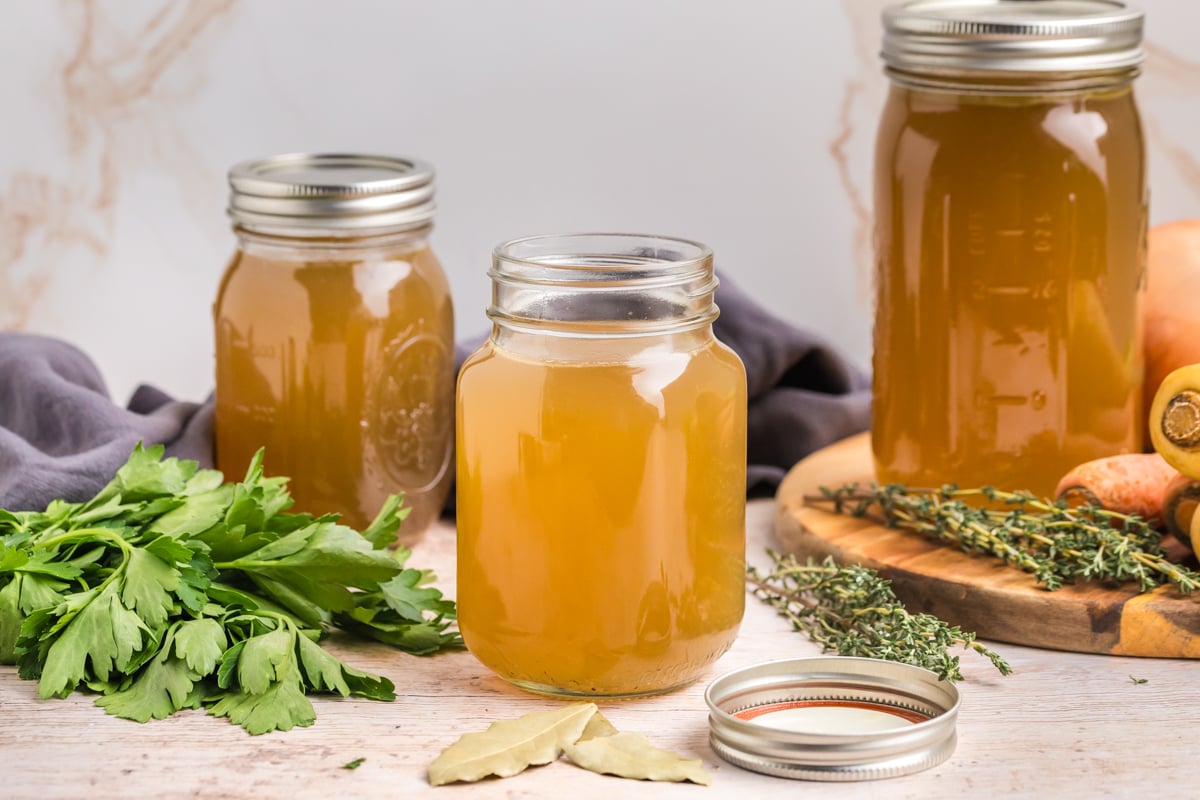 straight on shot of three mason jars of turkey stock