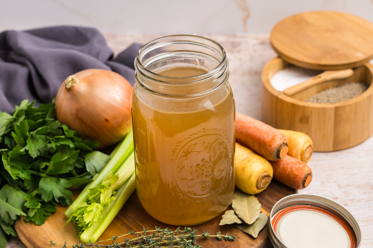 angled shot of mason jar of turkey stock