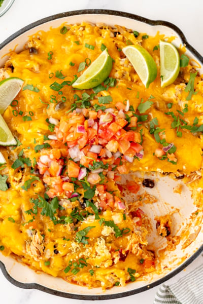 overhead shot of slice taken out of chicken enchilada casserole