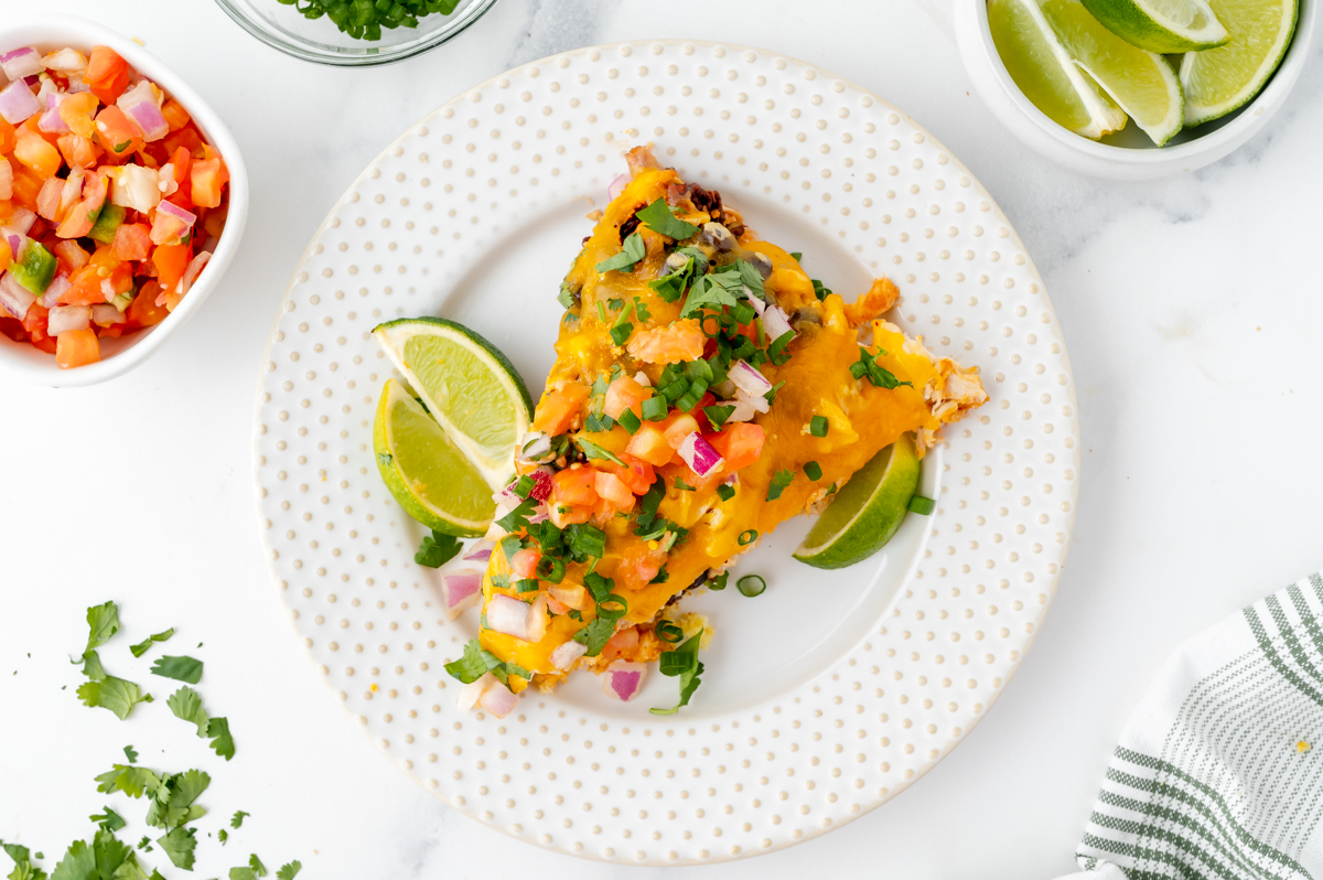 overhead shot of slice of chicken enchilada casserole on plate