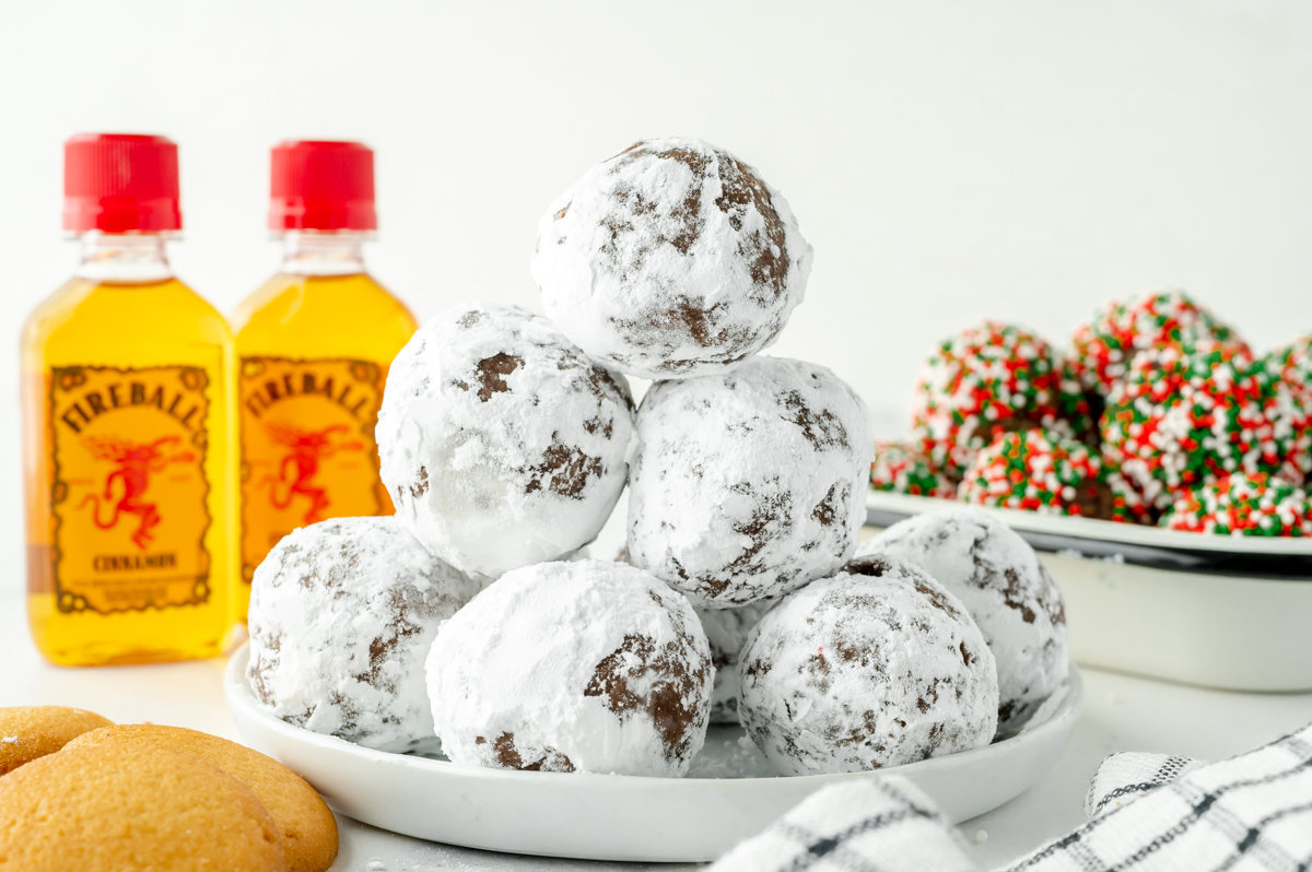 straight on shot of plate of powdered sugar coated fireball chocolate truffles