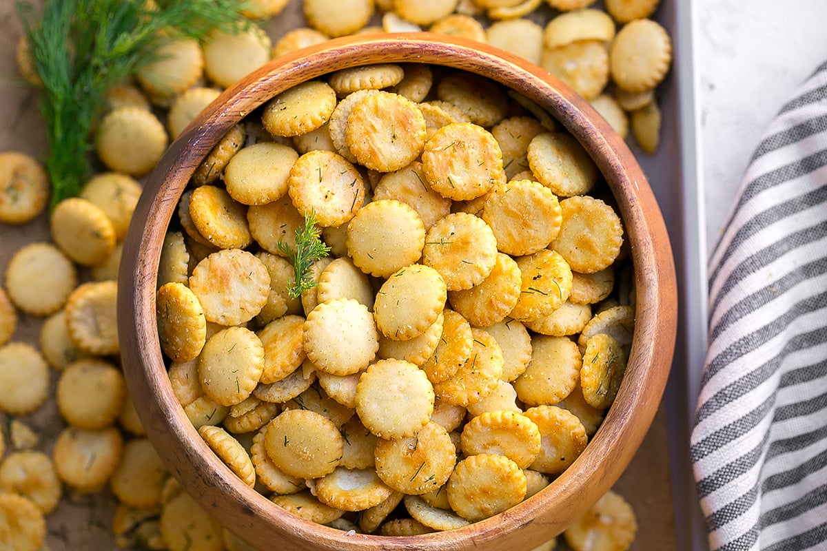 close up overhead shot of garlic dill oyster crackers in wooden bowl