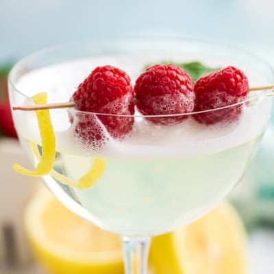 close up shot of raspberries in cocktail