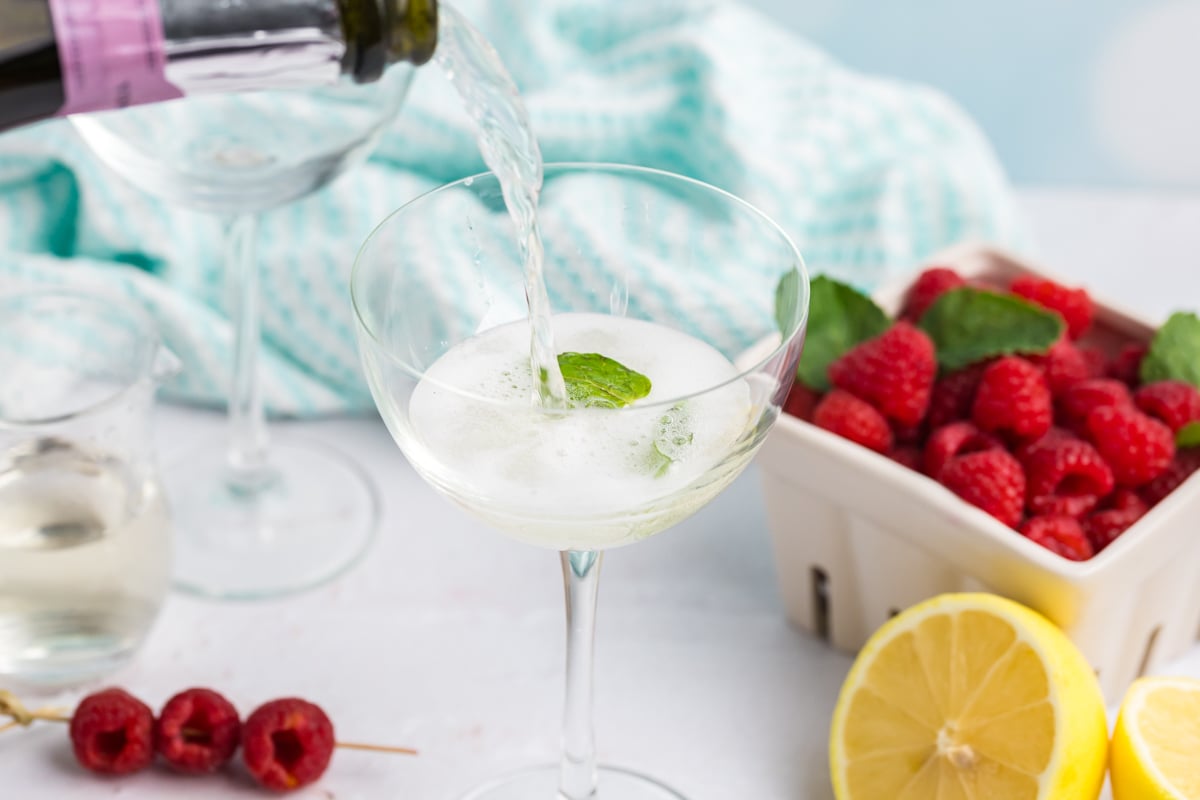 prosecco poured into glass with mint