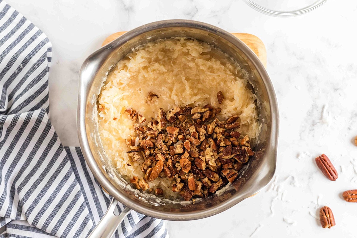 coconut frosting in pan with nuts