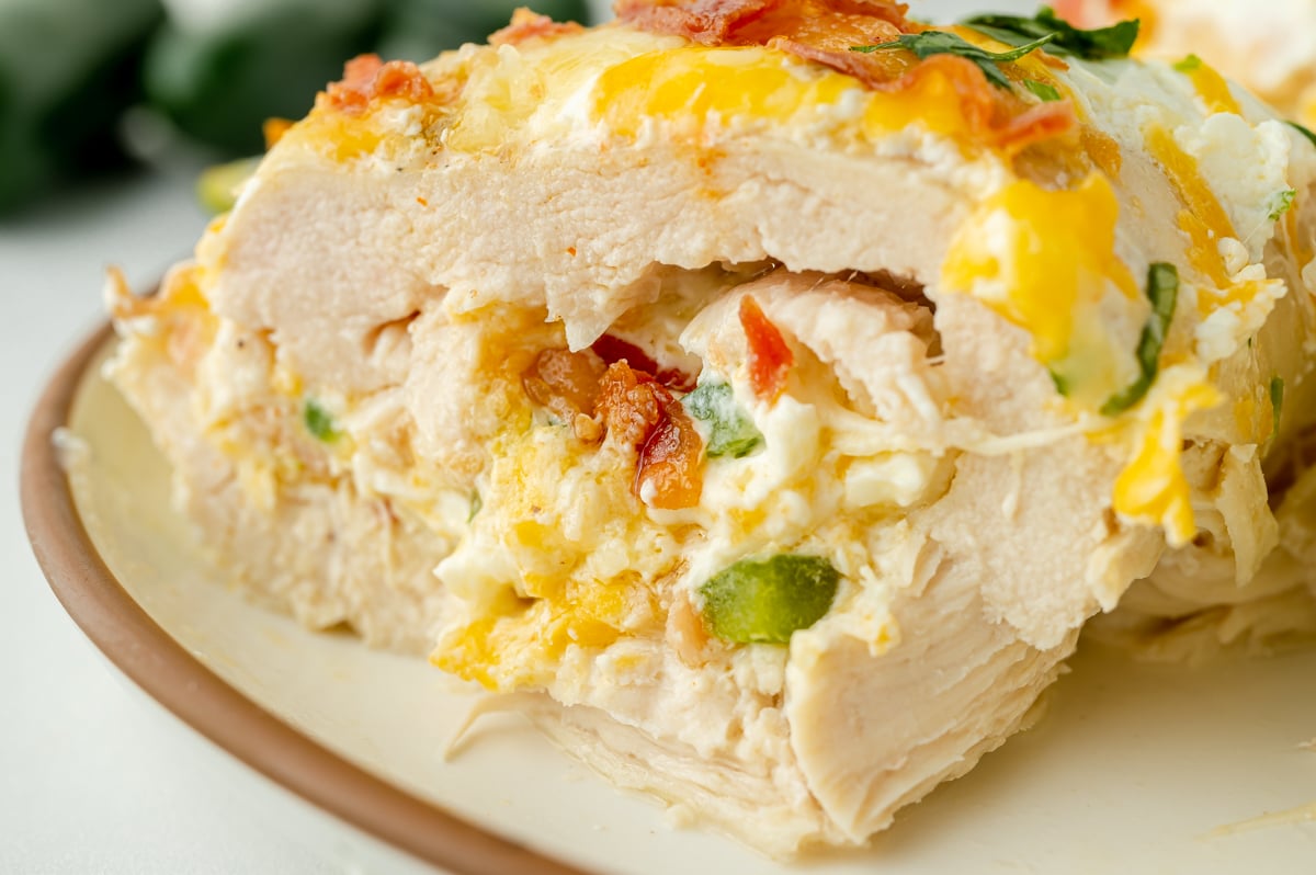 close up angled shot of creamy stuffed chicken cut in half