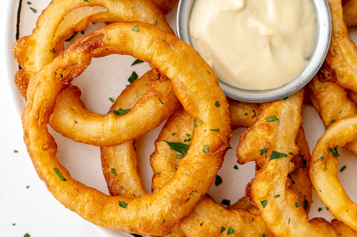 overhead shot of onion rings with bowl of dipping sauce