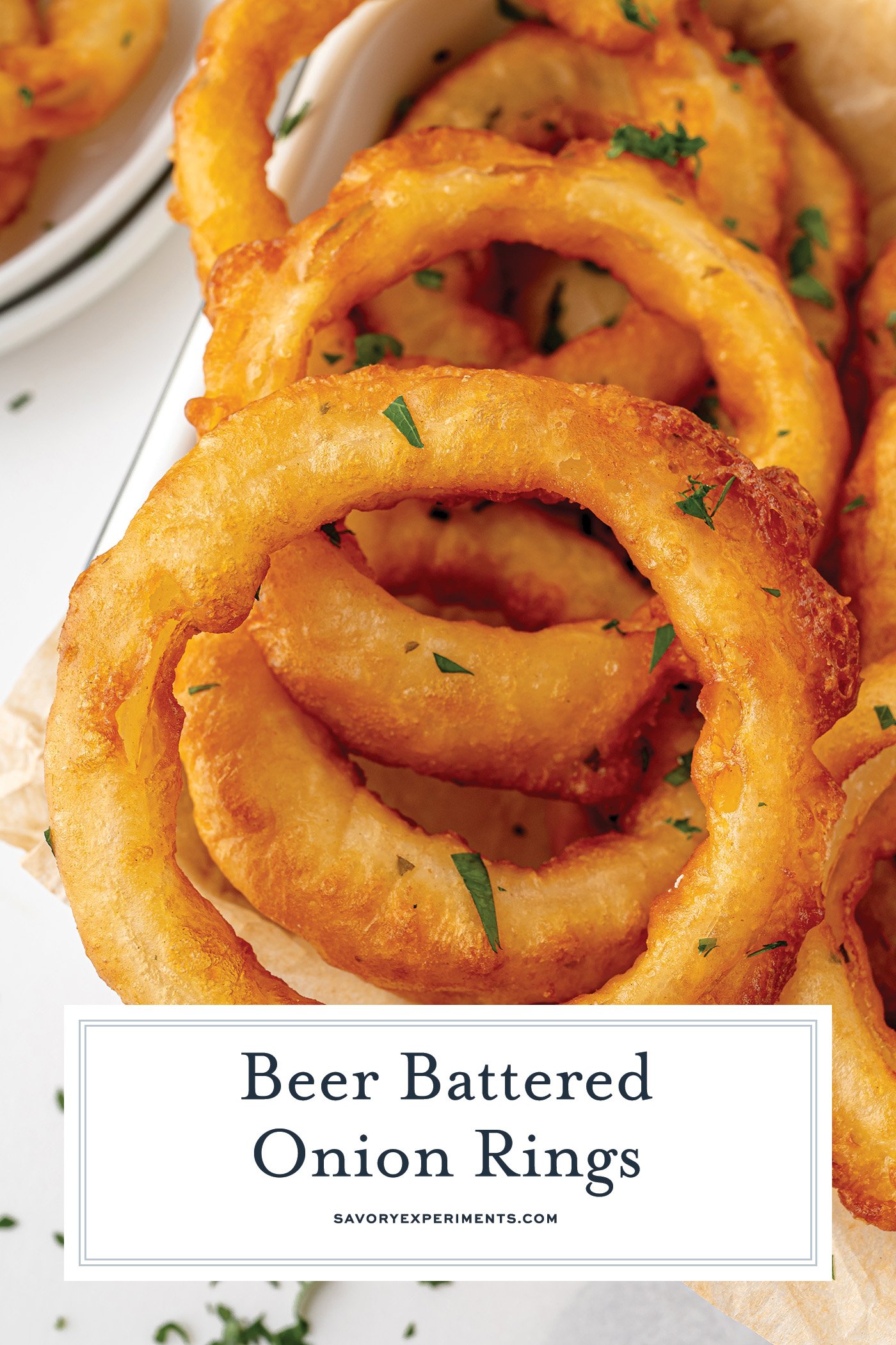 close up overhead shot of beer battered onion rings with text overlay