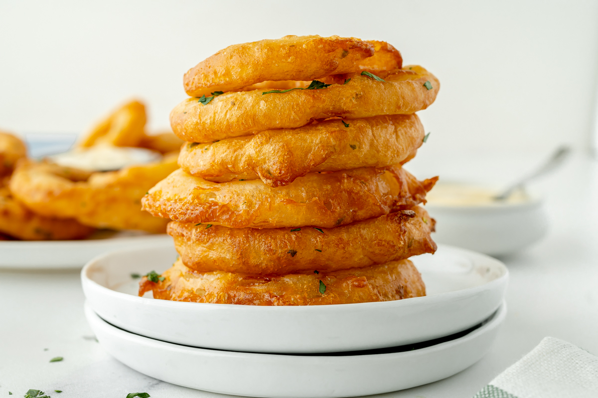 straight on shot of stack of onion rings on plate