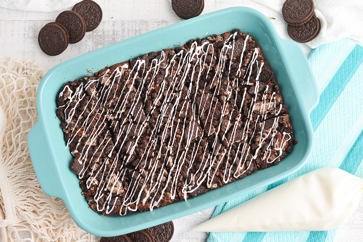 overhead shot of pan of oreo brownies drizzled with icing