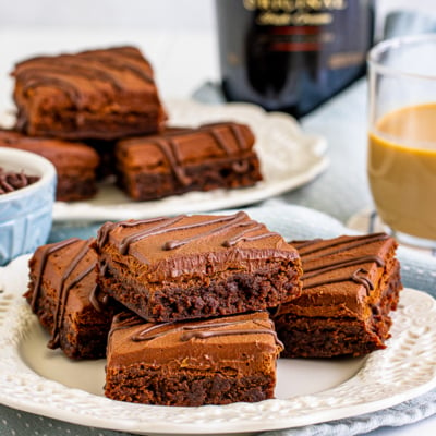 straight on shot of plate of brownies with cup of bailey's in background