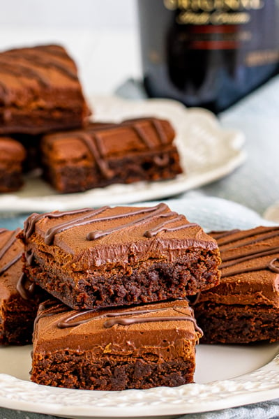 straight on shot of plate of brownies with cup of bailey's in background