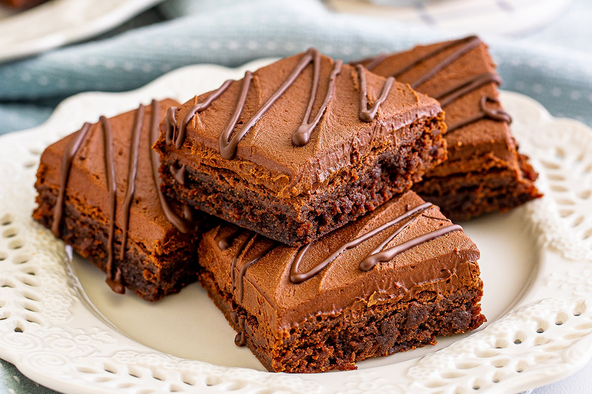 close up angled shot of four bailey's brownies on plate