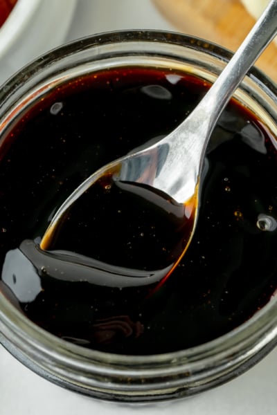 overhead shot of spoon in jar of balsamic glaze