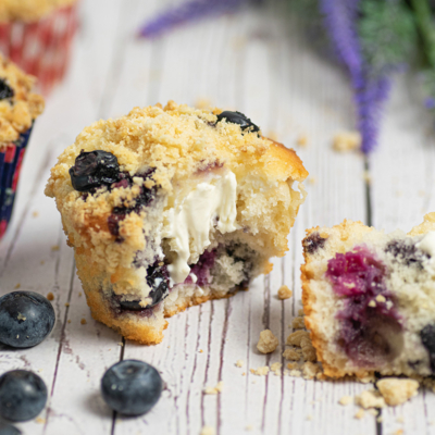 angled shot of blueberry cream cheese muffin cut in half