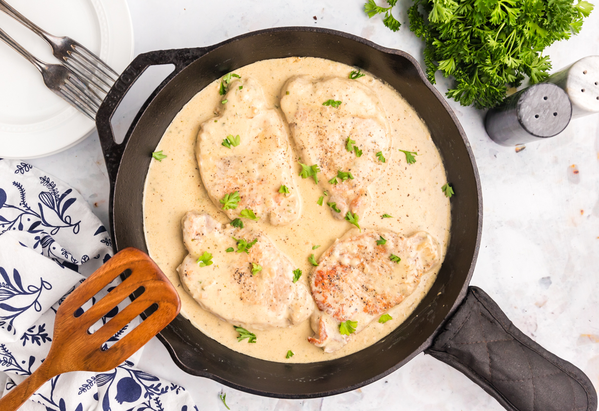 overhead shot of skillet of boursin pork chops