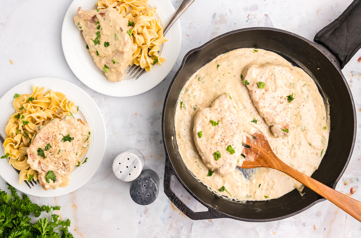 overhead shot of boursin pork chops in skillet and on plates