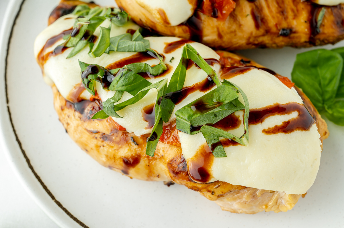 close up overhead shot of caprese chicken on plate