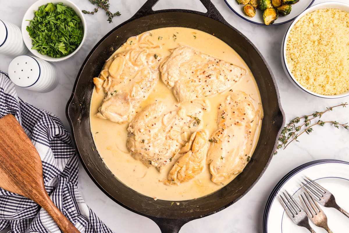 overhead shot of chicken in pan with creamy dijon sauce