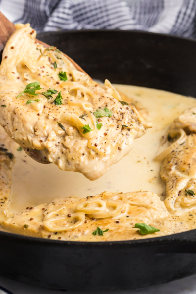 angled shot of spatula removing chicken dijon from pan