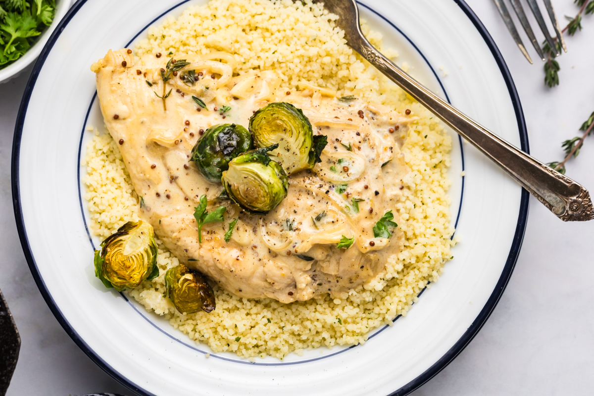 overhead shot of creamy dijon chicken over couscous