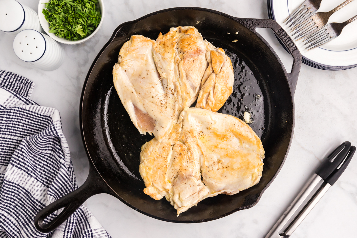 chicken breasts sautéing in pan