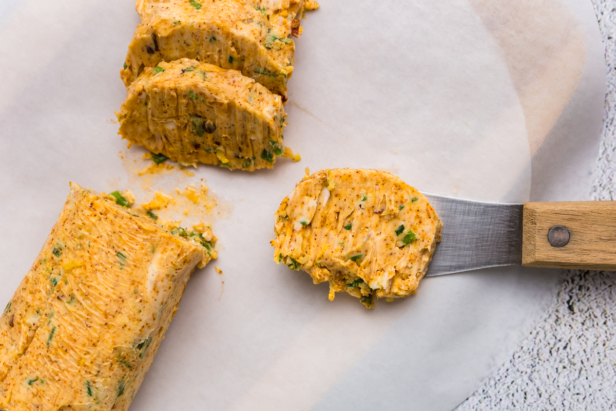 overhead shot of butter knife with pat of spicy butter on it