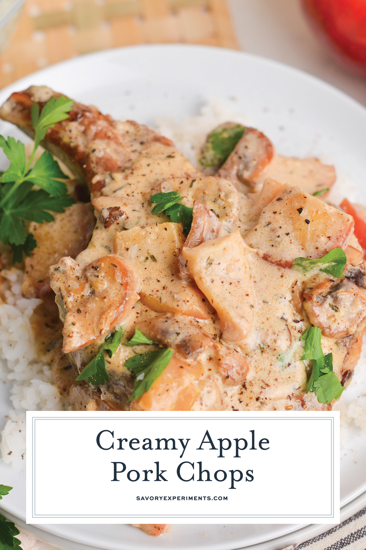 angled shot of creamy apple pork chops with text overlay