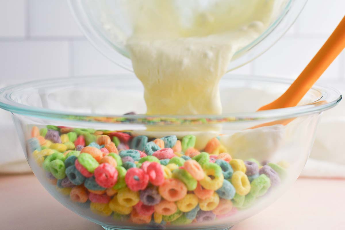 melted marshmallows pouring into bowl of fruit loops