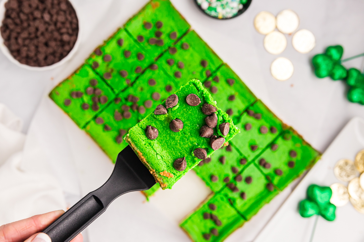 overhead shot of grasshopper cheesecake bar on spatula