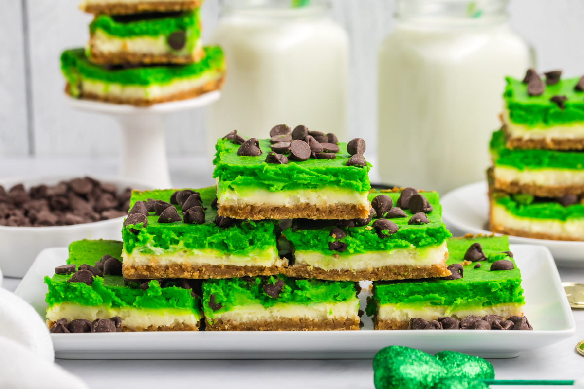 straight on shot of stack of grasshopper cheesecake bars on platter