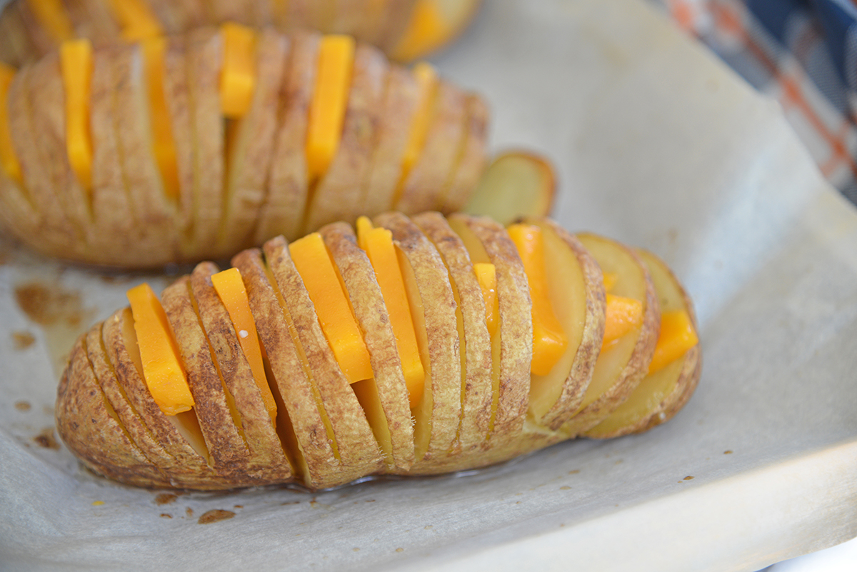 cheddar slices in between sliced potatoes