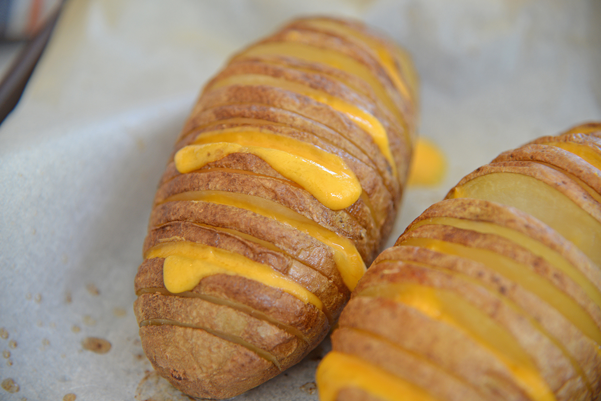 angled shot of hasselback potatoes with cheese