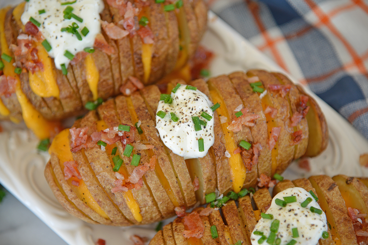 close up overhead shot of three hasselback potatoes on platter