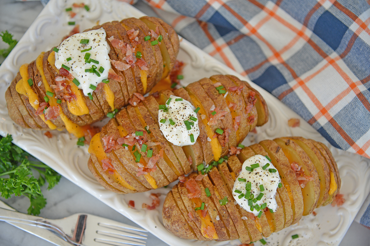 overhead shot of three hasselback potatoes on platter