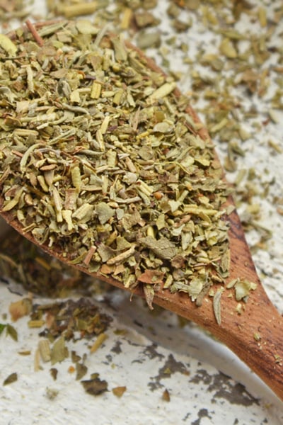 close up of italian spices in a wooden spoon