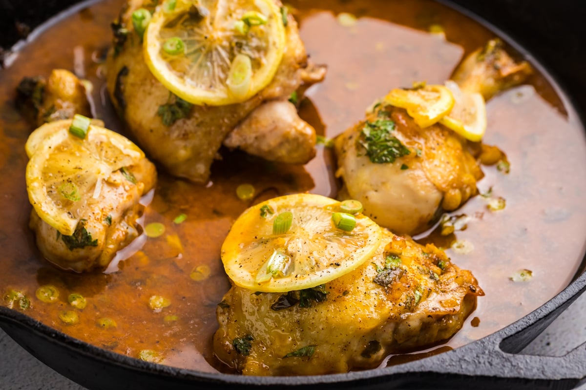 angled shot of honey lemon garlic chicken in skillet