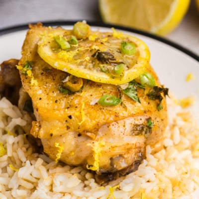 close up angled shot of honey lemon garlic chicken over rice