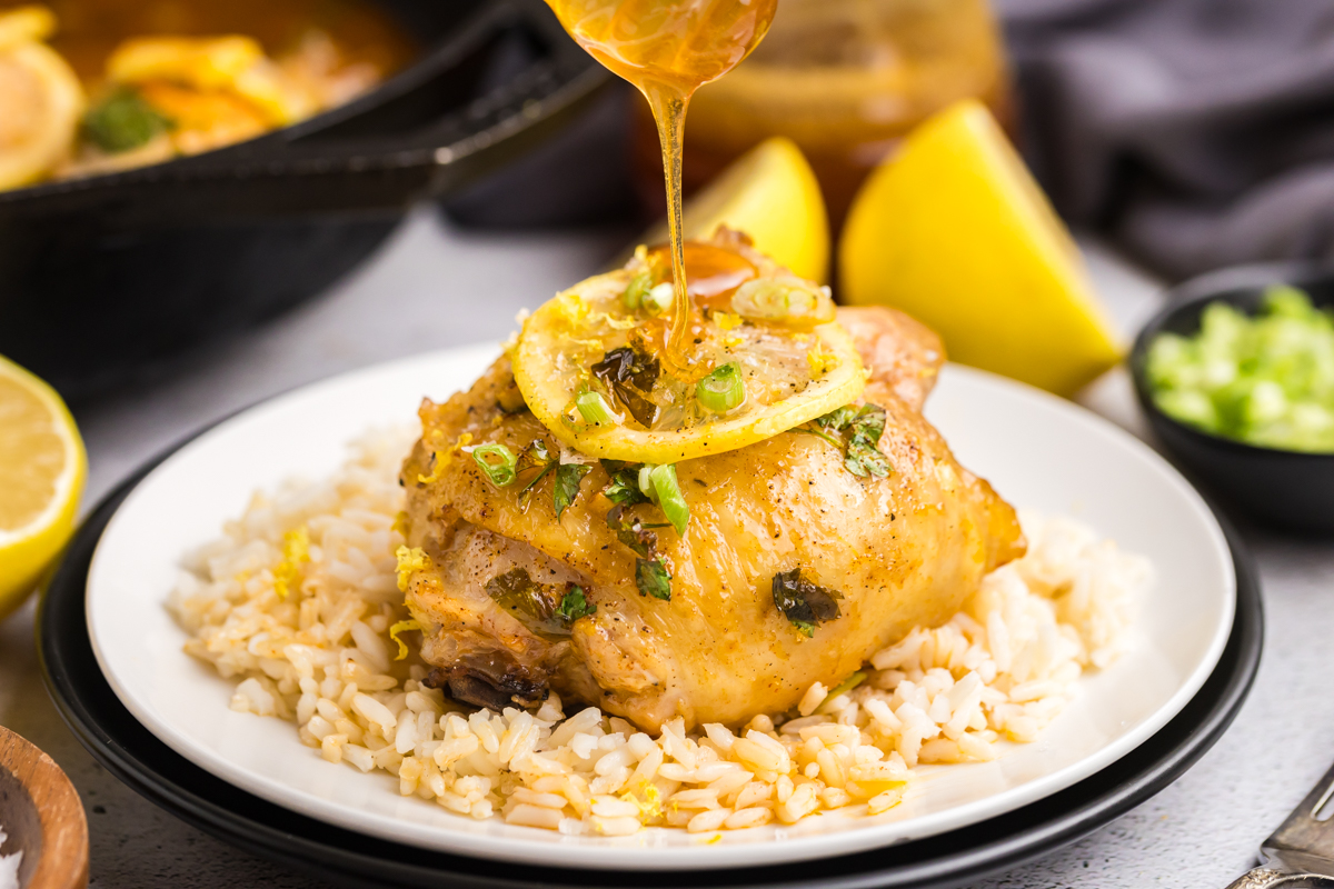 straight on shot of honey drizzling over lemon chicken