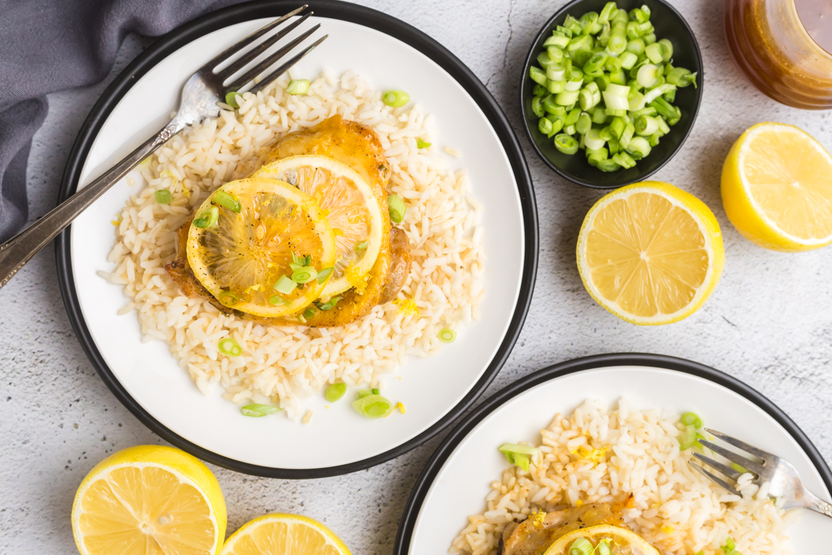 overhead shot of plates of lemon chicken over rice