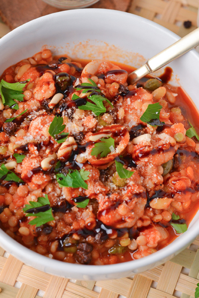 angled shot of spoon in bowl of cioppino