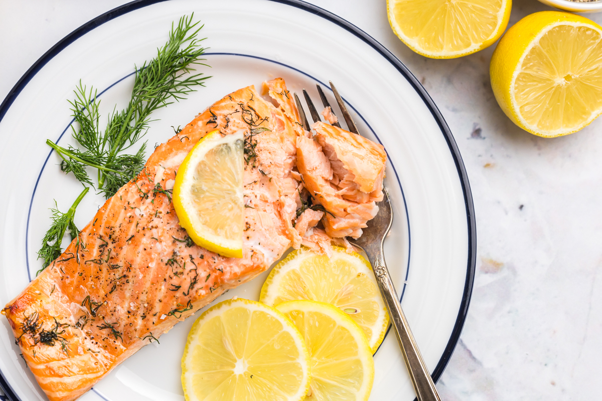 overhead shot of fork digging into lemon dill salmon