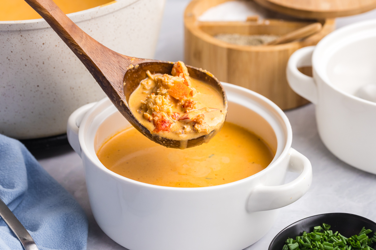 angled shot of ladle adding soup to bowl