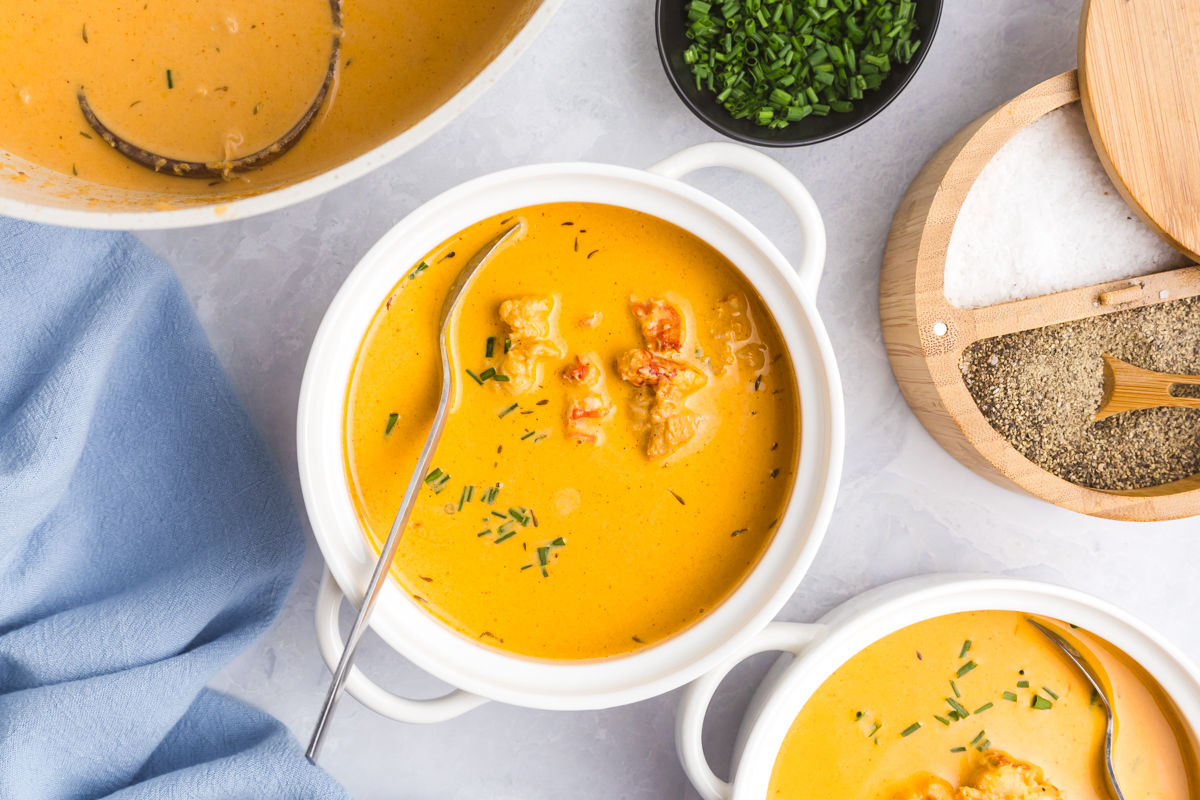 overhead shot of spoon in bowl of lobster bisque