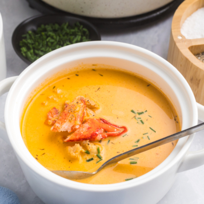 angled shot of spoon in bowl of lobster bisque