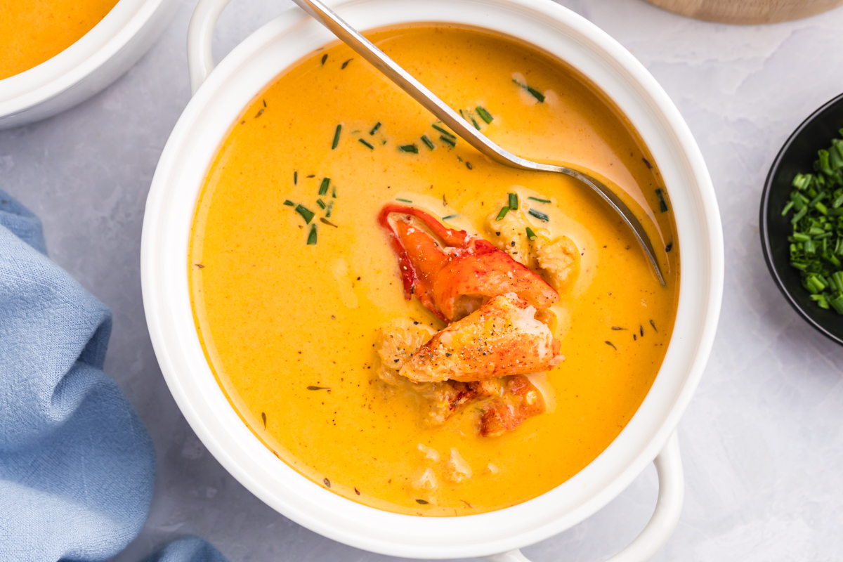 close up overhead shot of spoon in bowl of lobster bisque